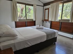 Queen sized bed in one of the Bungalows main bedrooms